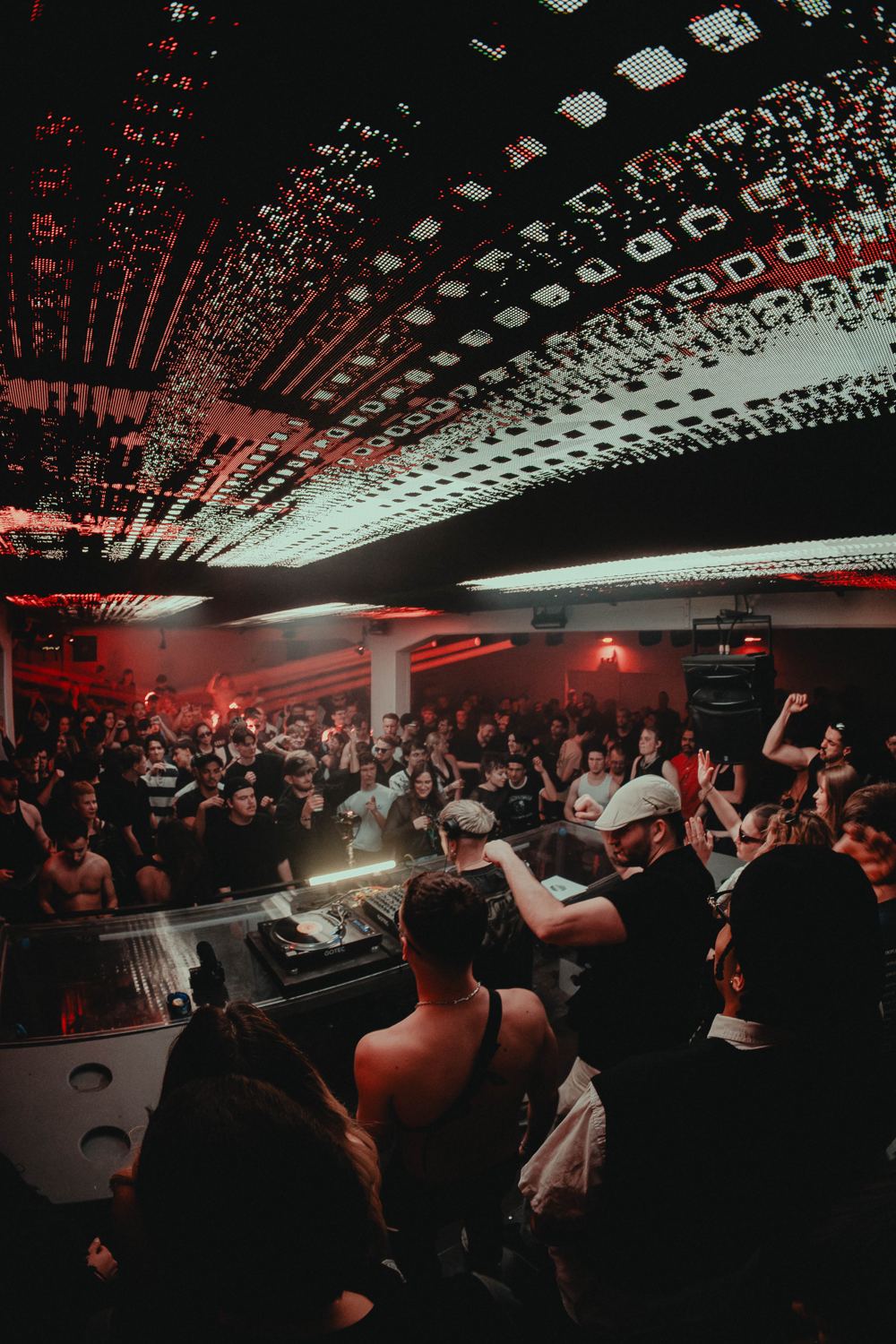 View over the DJ booth into the crowd